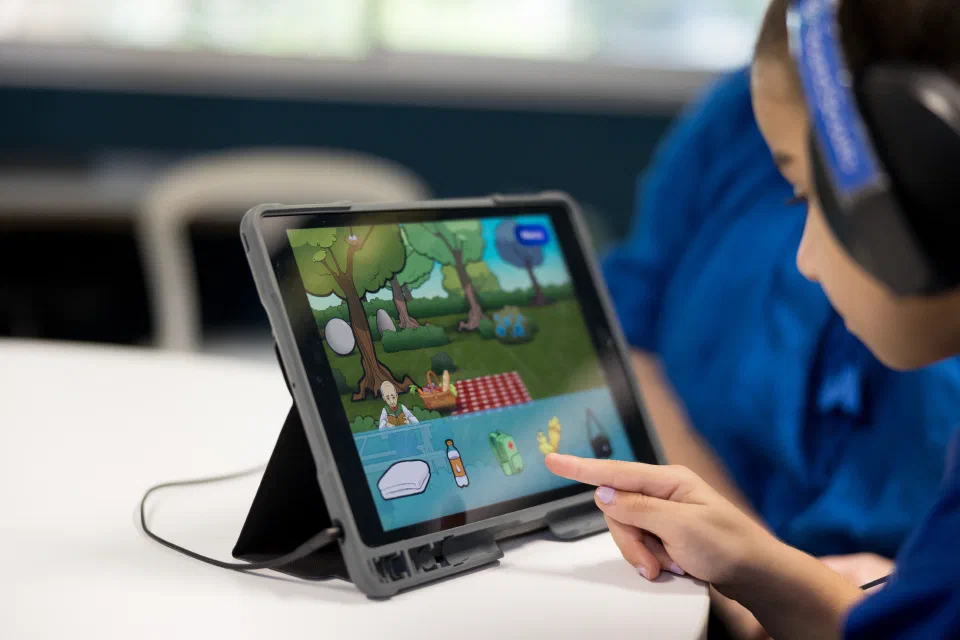 Child wearing headphones using Sound Scouts App.